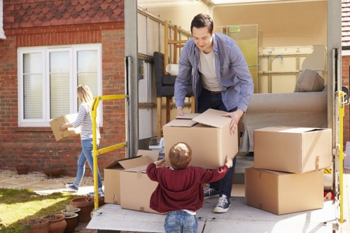 Removal team preparing a flat move in Dulwich with boxes and furniture