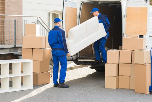 Movers handling furniture through a residential property in Dulwich