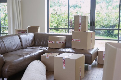 Removal crew transporting furniture through a Dulwich property entrance